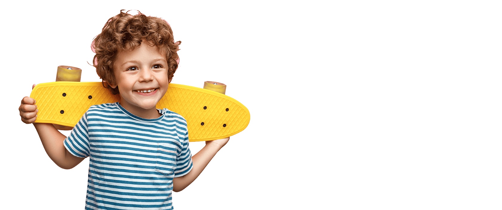 smiling boy holding his skateboard behind his head